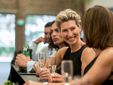 Woman at bar drinking with colleague